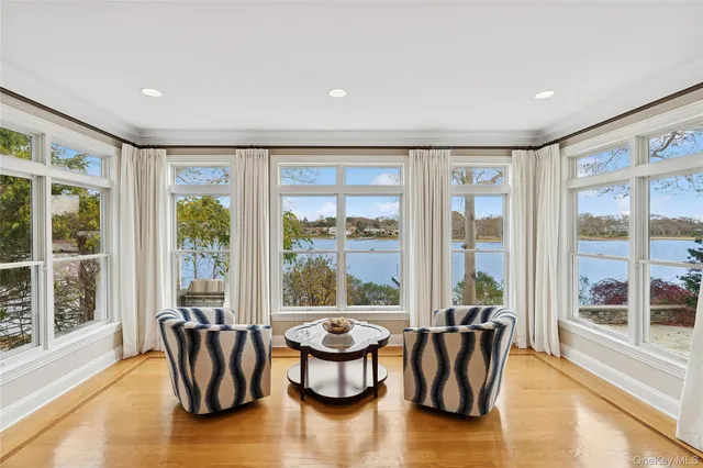 a living room with furniture and floor to ceiling windows