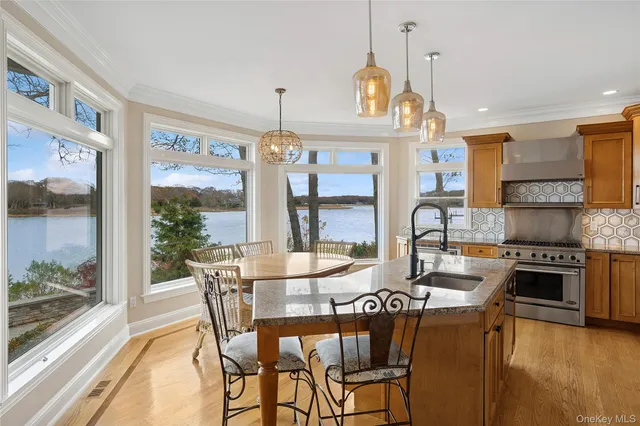a view of a dining room with furniture a chandelier and wooden floor