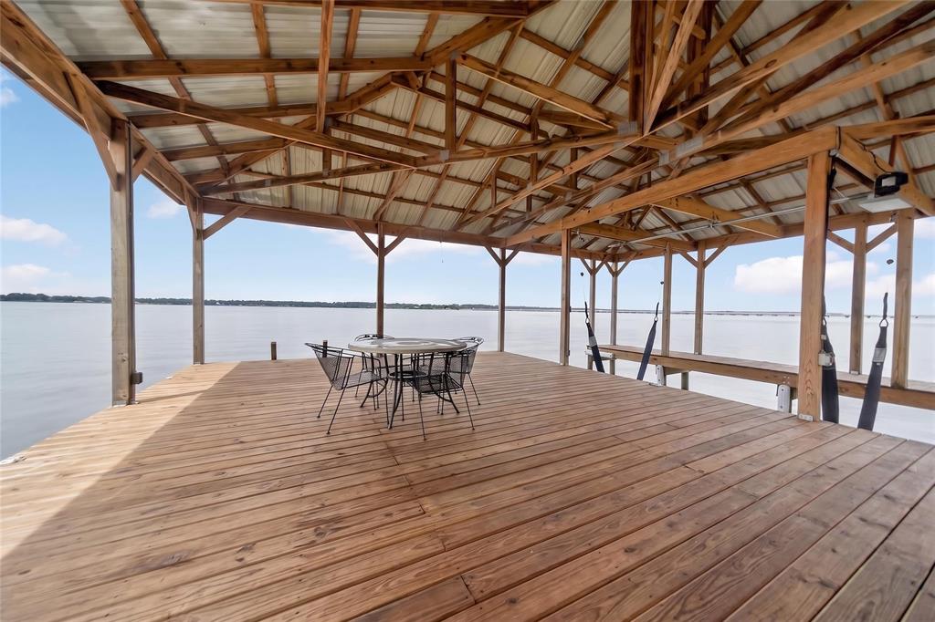 23363 Wateridge Loop Flint, TX 75762 - Photo 12 of 40 a view of a patio with table and chairs with wooden floor and fence