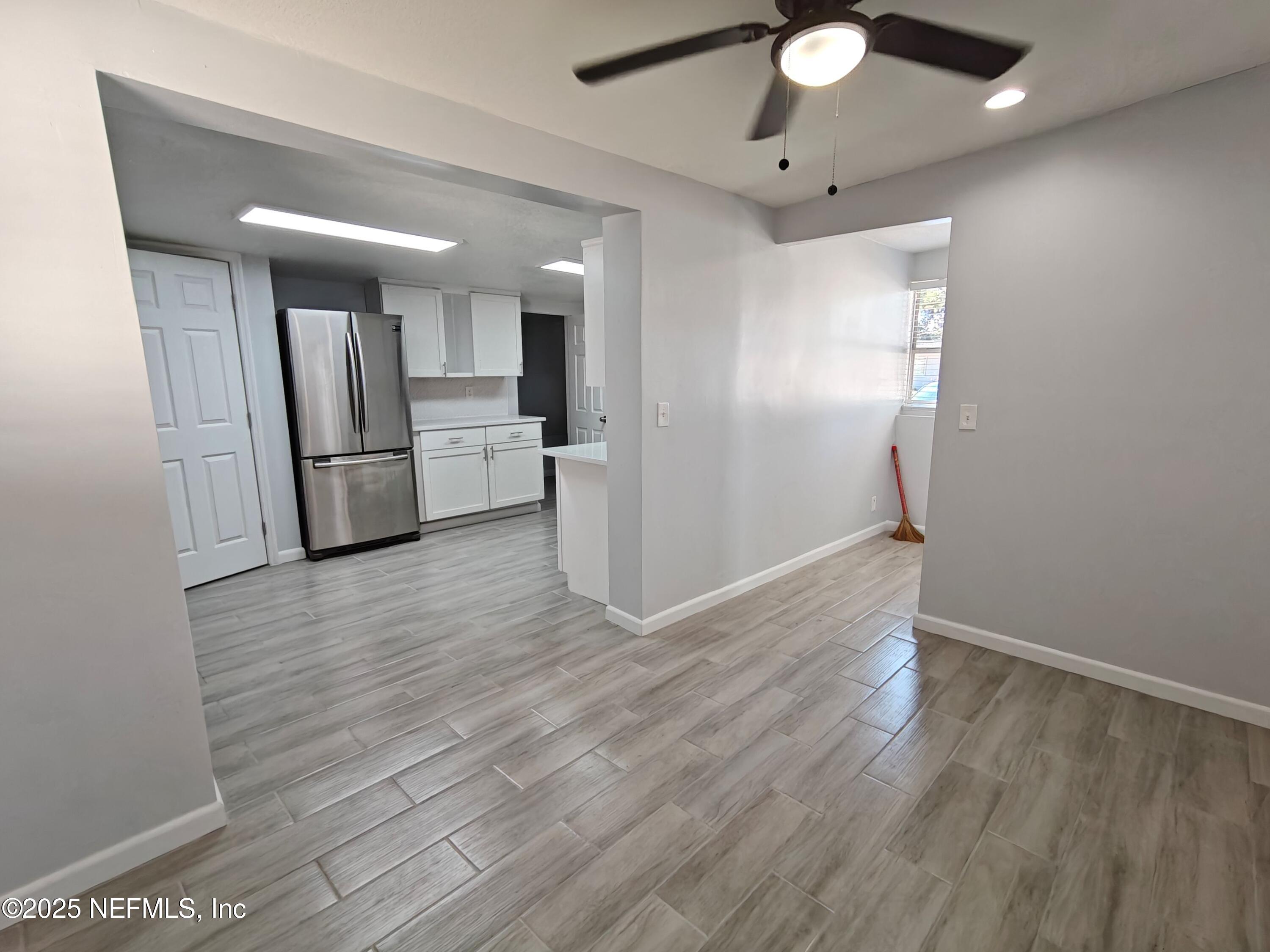 2921 Mansion Road Jacksonville, FL 32277 - Photo 12 of 40 a view of a kitchen with a sink and a refrigerator