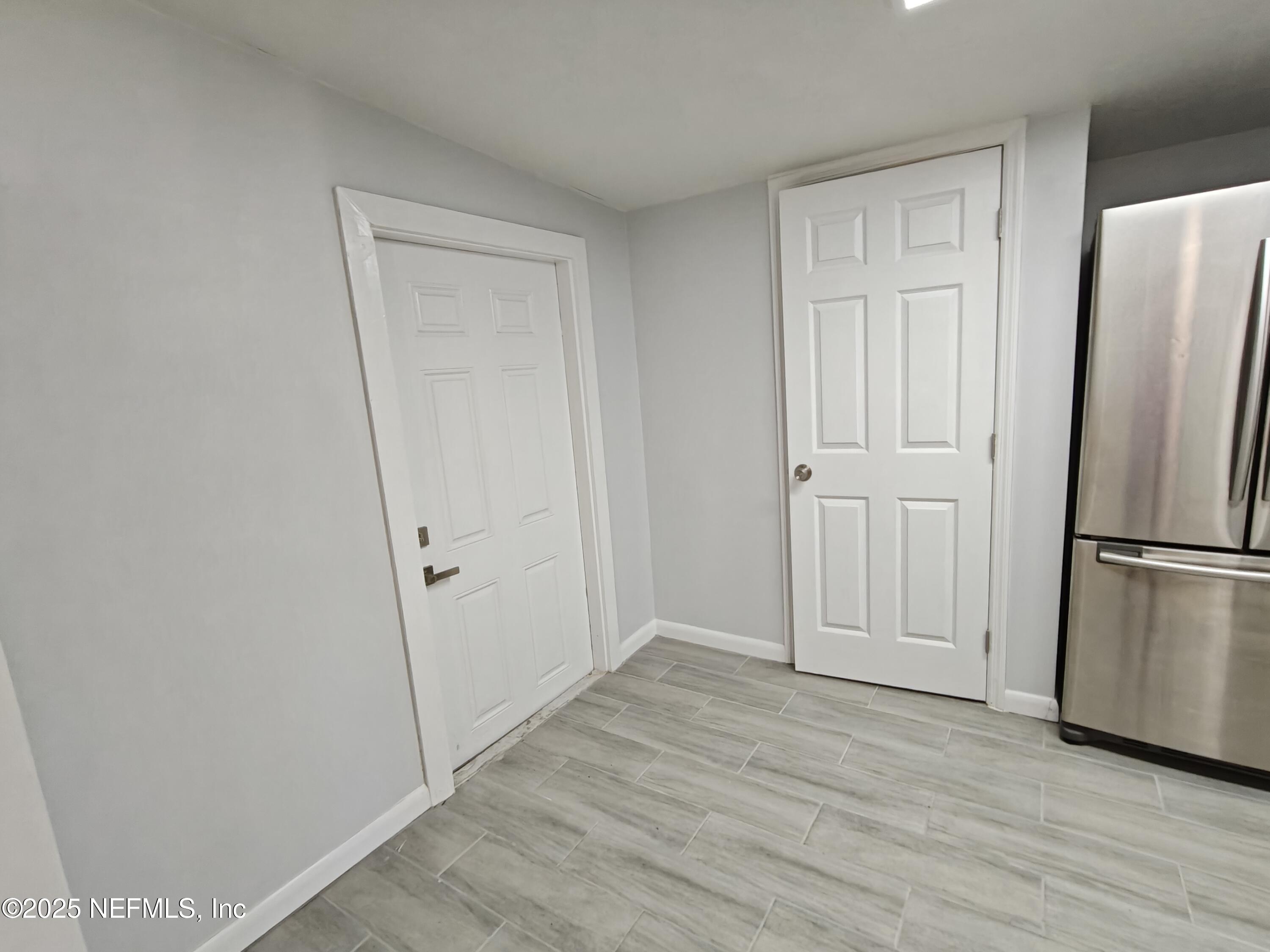 2921 Mansion Road Jacksonville, FL 32277 - Photo 20 of 40 a view of empty room with wooden floor