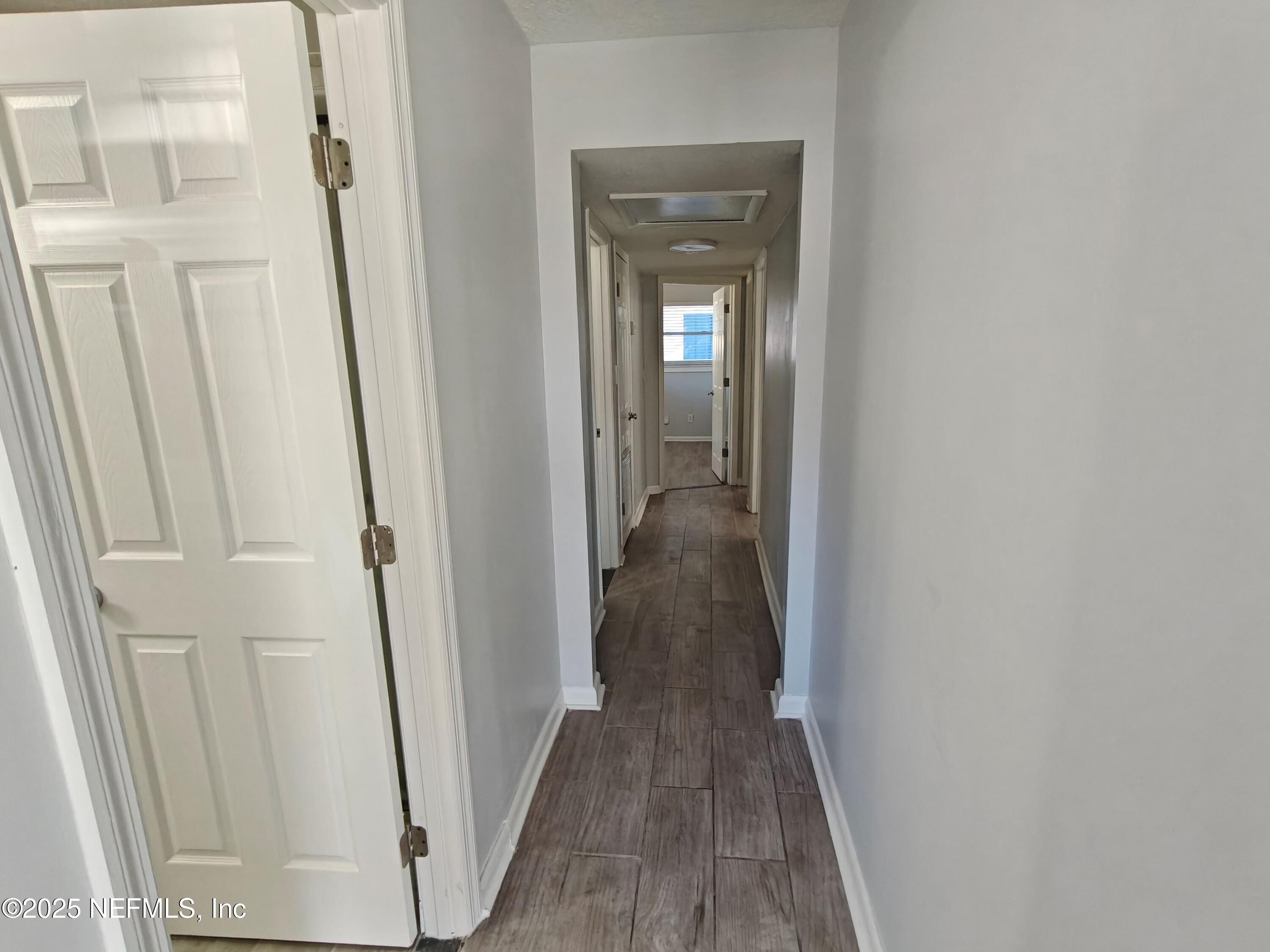 2921 Mansion Road Jacksonville, FL 32277 - Photo 22 of 40 a view of a hallway with wooden floor