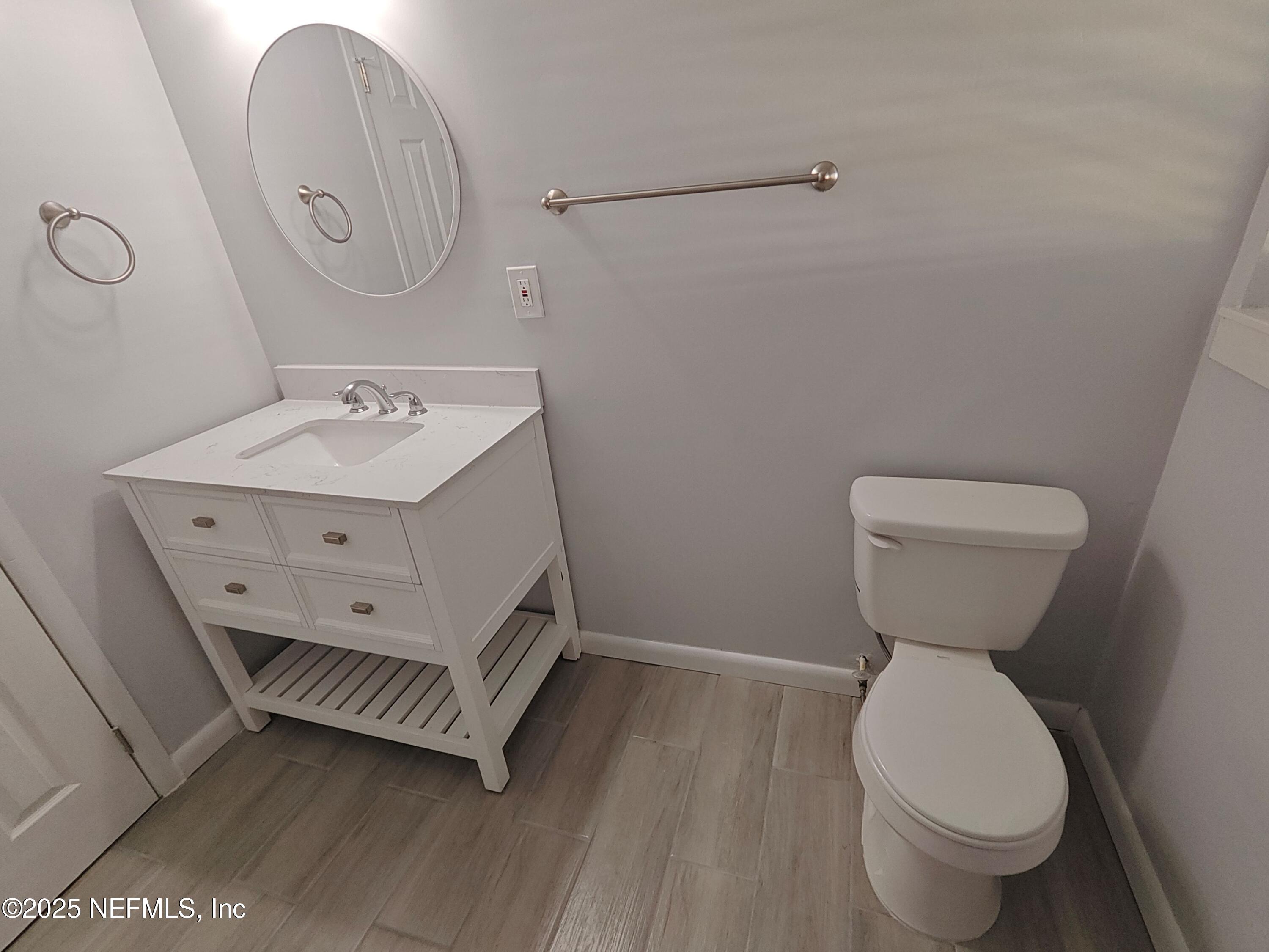2921 Mansion Road Jacksonville, FL 32277 - Photo 31 of 40 a bathroom with a toilet sink and mirror