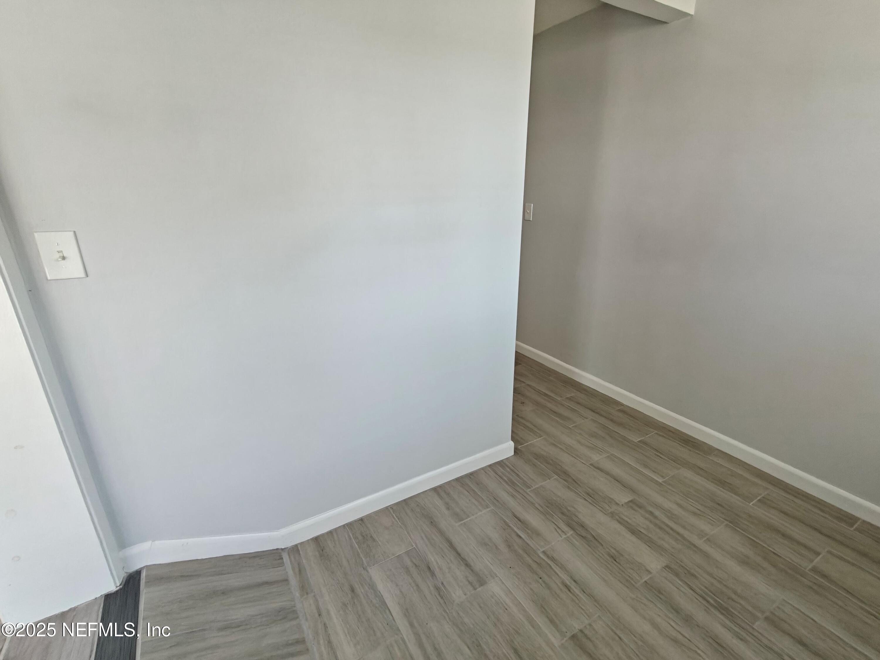 2921 Mansion Road Jacksonville, FL 32277 - Photo 6 of 40 wooden floor in an empty room