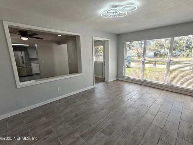 a kitchen with white cabinets and appliances