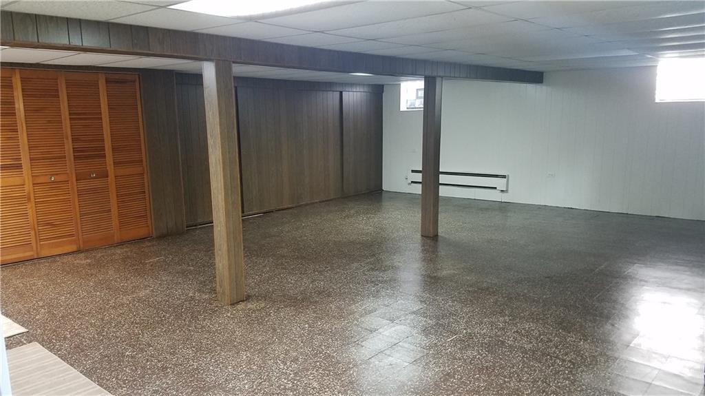 4021 Portman Avenue Pittsburgh, PA 15214 - Photo 5 of 16 Entertaining in the spacious family room located in the lower level features sliding panel doors that open to reveal the laundry area. The washer/dryer and large second refrigerator are inclusions!