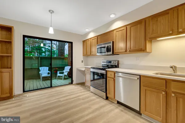 a view of a balcony with wooden floor and fence