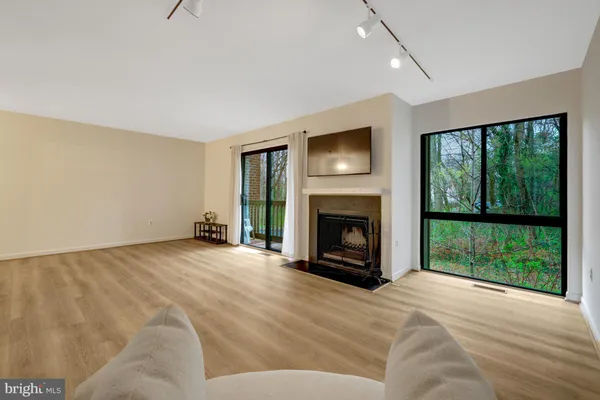 a view of empty room with wooden floor and fireplace