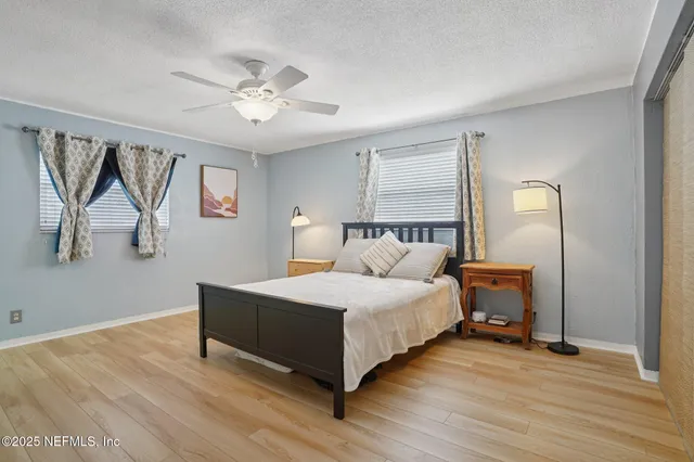 a spacious bedroom with a bed and a chandelier