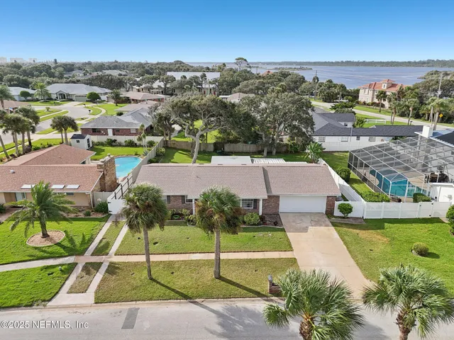 an aerial view of a house with a garden and trees
