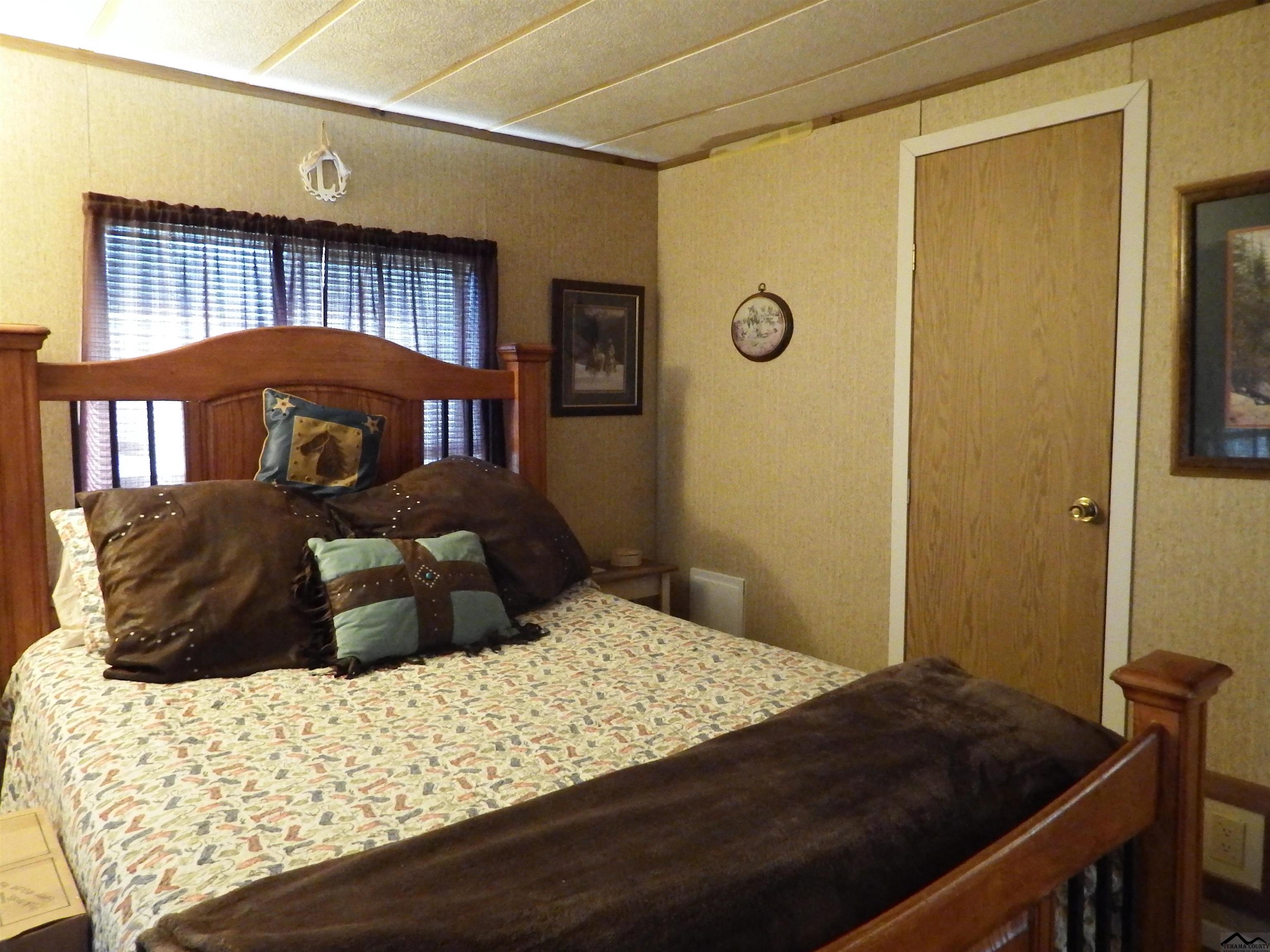 12535 Wilder Road Red Bluff, CA 96080 - Photo 12 of 30 a bedroom with a bed window and a dresser