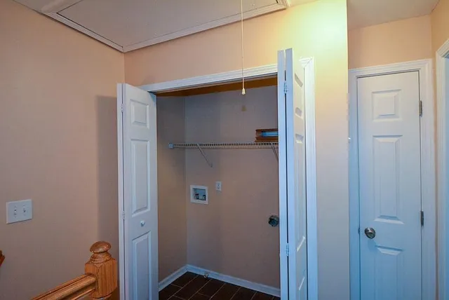 a view of a hallway with wooden floor and entryway