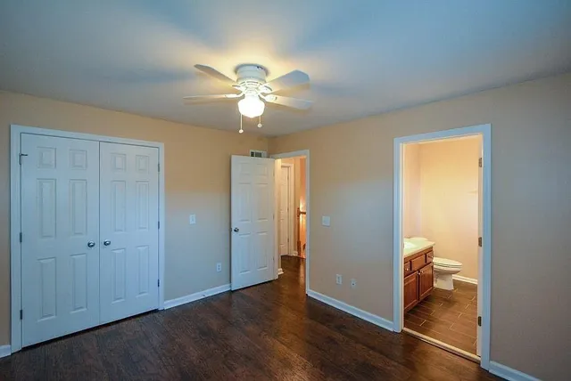a view of a room with wooden floor and a ceiling fan