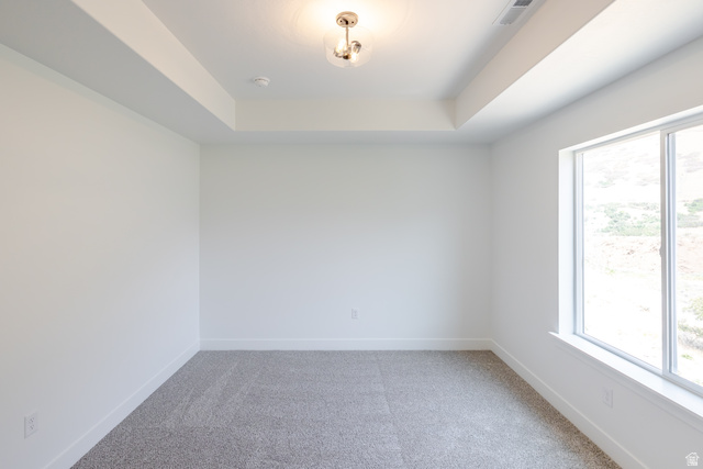 195 West Harmony Rdg Parkway, Unit 601 Mapleton, UT 84664 - Photo 18 of 23 Spacious room featuring a tray ceiling, recessed lighting, and a large window