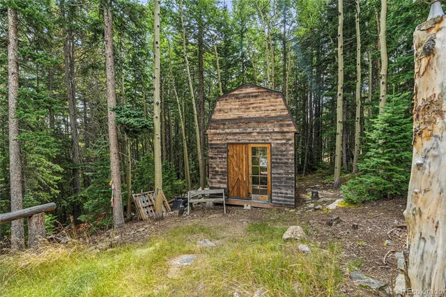 a view of a house with backyard garden and sitting area