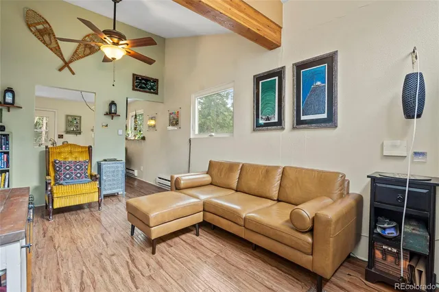 a living room with furniture a couch and a chandelier
