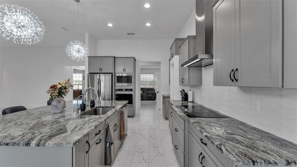 1029 Bergamot Drive Bartow, FL 33830 - Photo 23 of 62 a kitchen with stainless steel appliances granite countertop a sink refrigerator and microwave