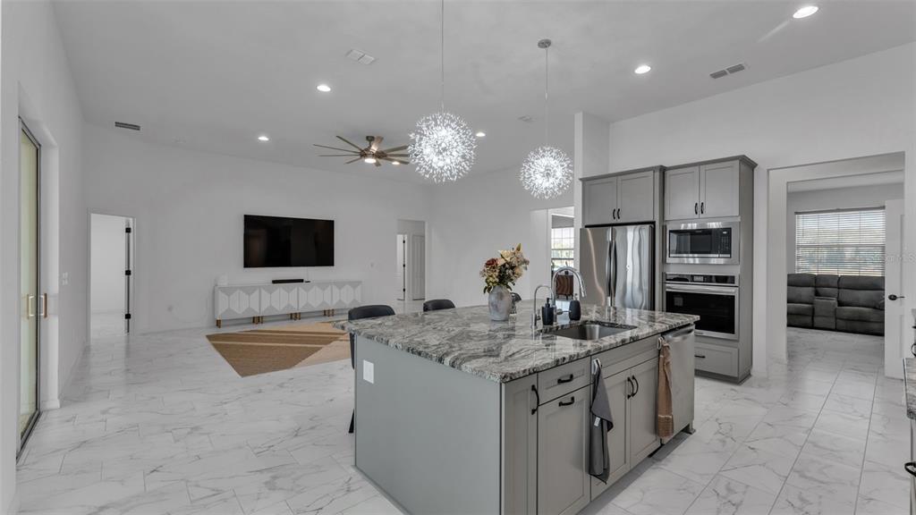 1029 Bergamot Drive Bartow, FL 33830 - Photo 24 of 62 a kitchen with stainless steel appliances granite countertop a sink and a refrigerator