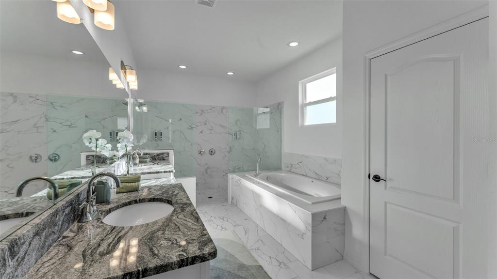 1029 Bergamot Drive Bartow, FL 33830 - Photo 31 of 62 a bathroom with a granite countertop sink a toilet a mirror and shower