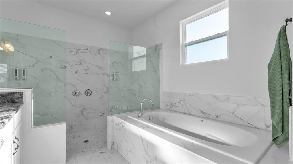 1029 Bergamot Drive Bartow, FL 33830 - Photo 36 of 62 a bathroom with a tub sink and a shower