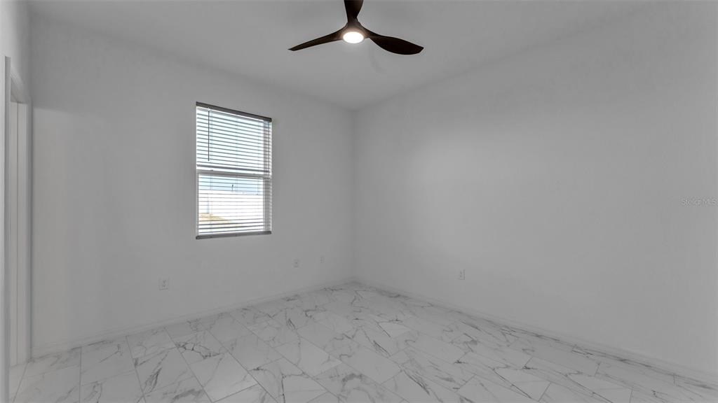 1029 Bergamot Drive Bartow, FL 33830 - Photo 38 of 62 an empty room with a window and a fan