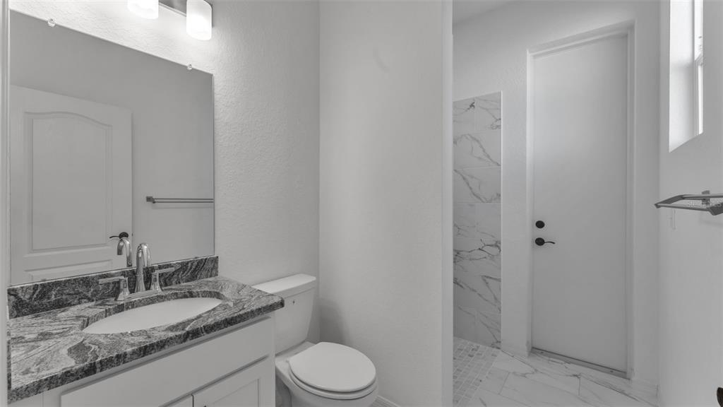 1029 Bergamot Drive Bartow, FL 33830 - Photo 41 of 62 a bathroom with a granite countertop sink toilet a mirror and shower
