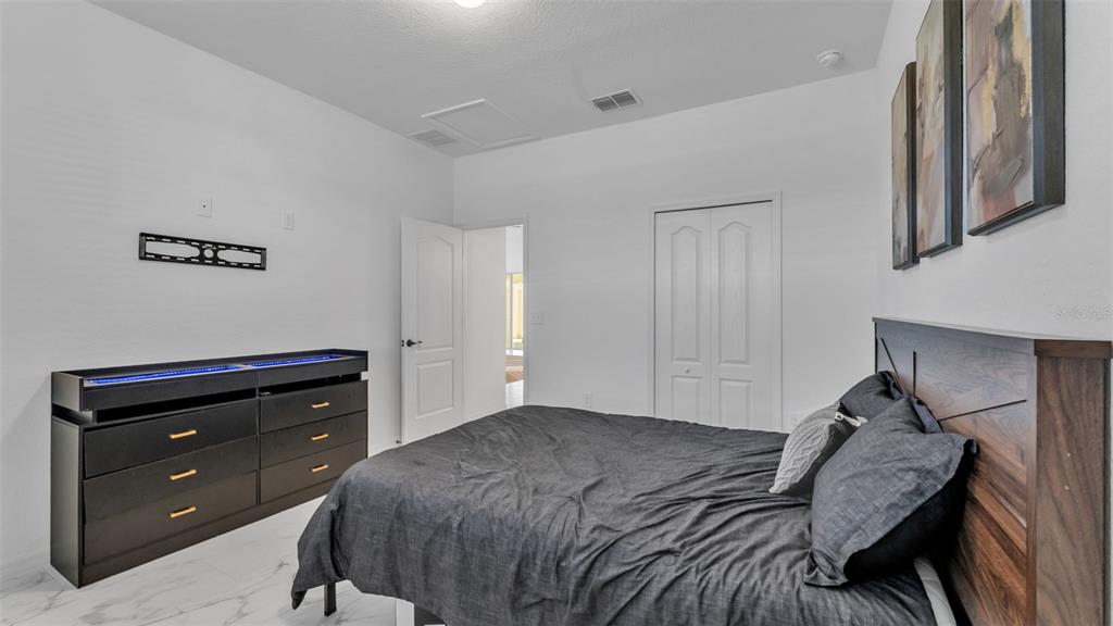 1029 Bergamot Drive Bartow, FL 33830 - Photo 48 of 62 a bedroom with a bed and a dresser