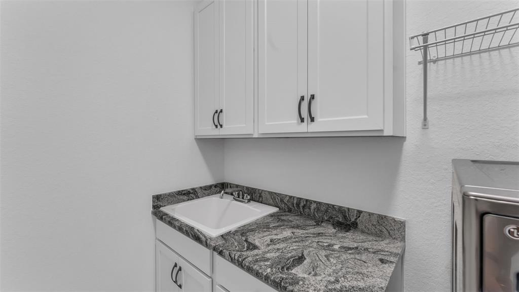 1029 Bergamot Drive Bartow, FL 33830 - Photo 51 of 62 a kitchen with a sink and cabinets