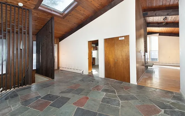 a view of a hallway with wooden walls