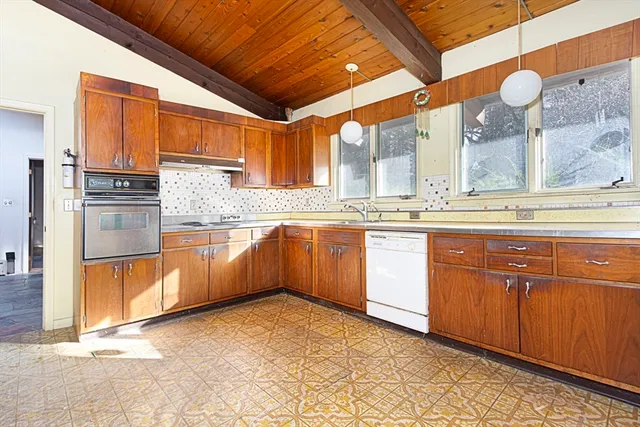 a kitchen with stainless steel appliances granite countertop a stove sink and cabinets