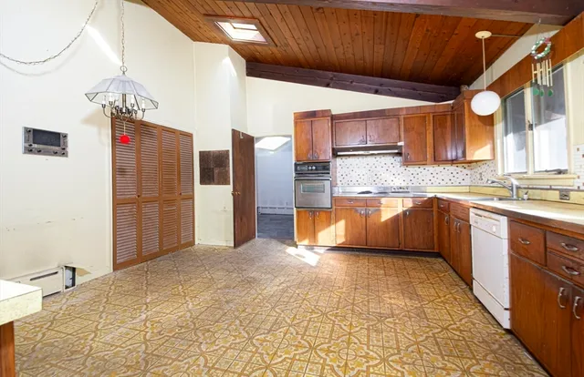 a kitchen with stainless steel appliances granite countertop a sink and cabinets