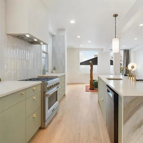 a kitchen with a sink stainless steel appliances and cabinets