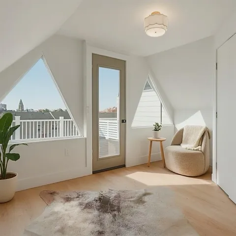 a view of a livingroom with furniture and staircase