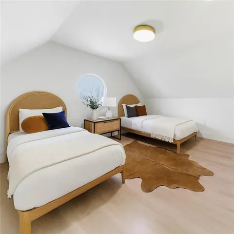 a bedroom with two beds and a rug