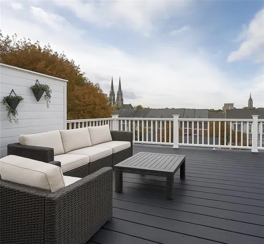 a view of a terrace with couches and wooden floor