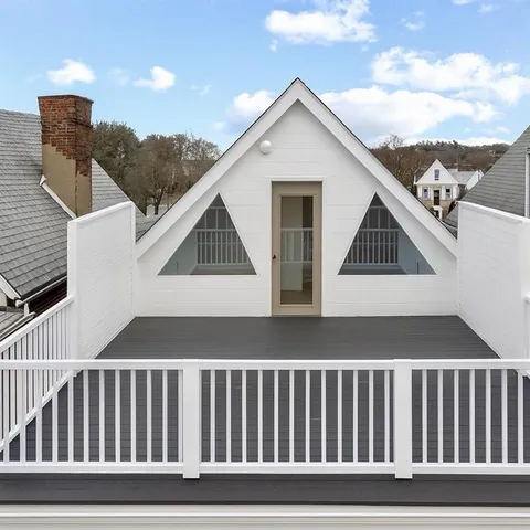 a view of a white house and a yard