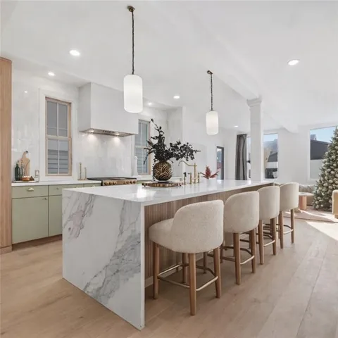 a kitchen with kitchen island granite countertop a table and chairs in it