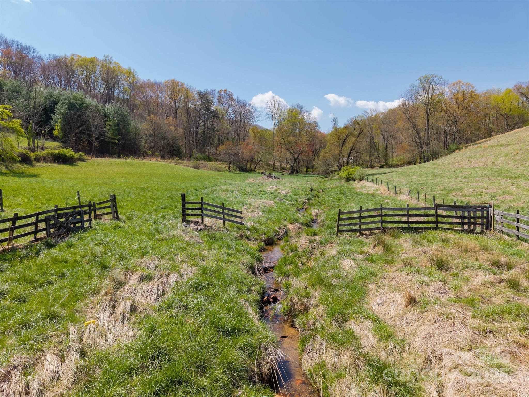 435 Upper Glady Fork Road Candler, NC 28715 - Photo 13 of 47 a view of a green field with trees in the background