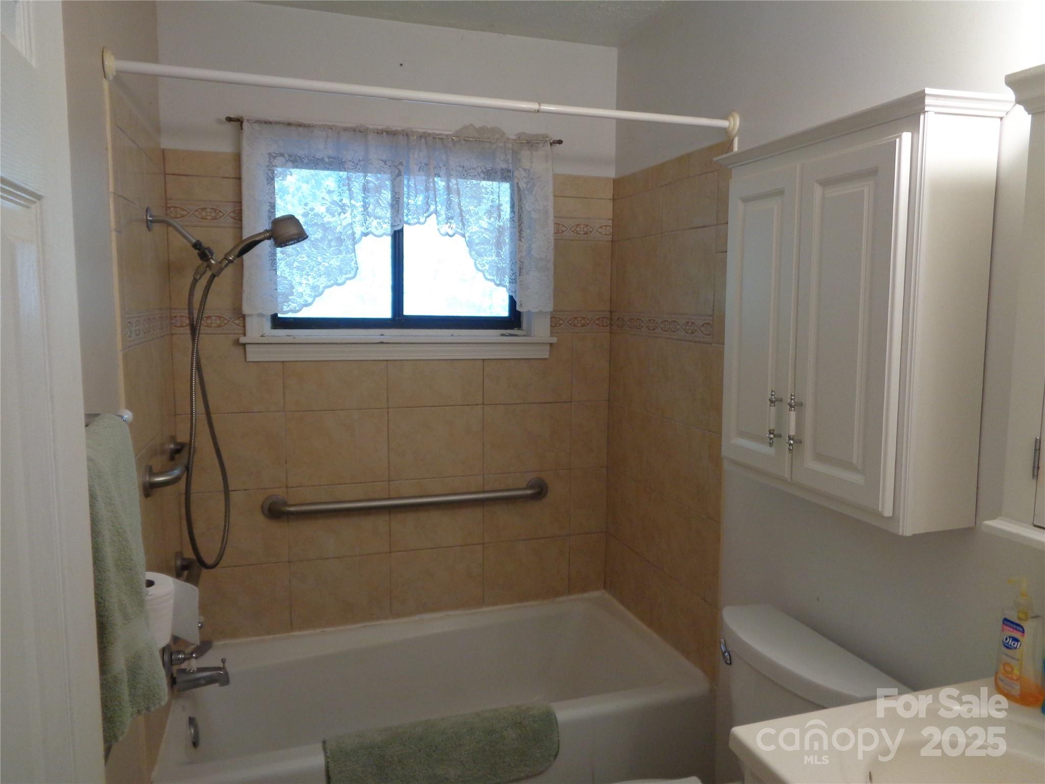 435 Upper Glady Fork Road Candler, NC 28715 - Photo 38 of 47 a bathroom with a window bathtub and shower