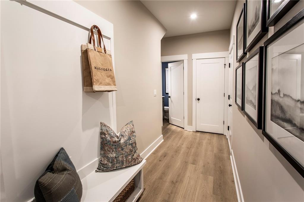 4705 Montane Street Cumming, GA 30028 - Photo 31 of 55 a view of a hallway with wooden floor and furniture