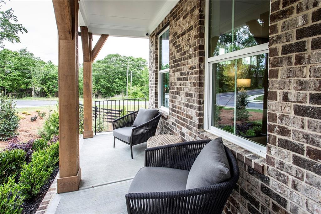 4705 Montane Street Cumming, GA 30028 - Photo 5 of 55 a view of a balcony with two chairs and a potted plant