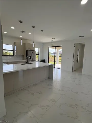 a large kitchen with stainless steel appliances granite countertop a large counter top and a stove