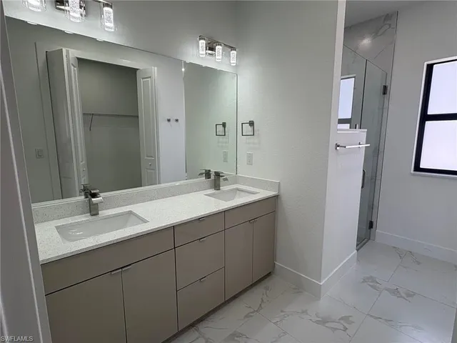 a bathroom with a double vanity sink and mirror