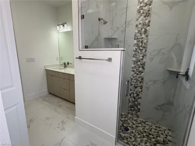 a bathroom with a shower toilet and sink