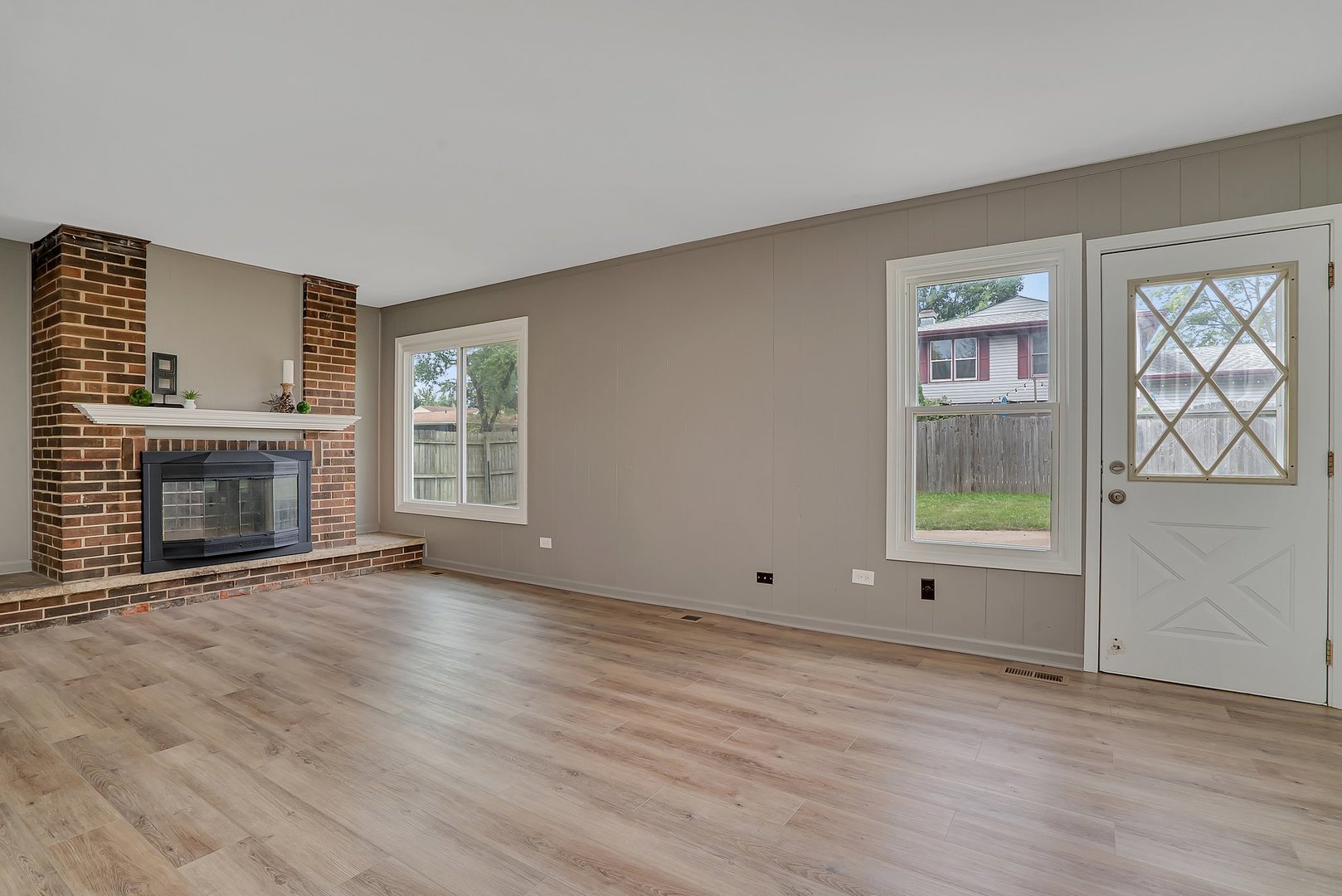 161 South Schmidt Road Bolingbrook, IL 60440 - Photo 14 of 26 an empty room with windows fireplace and wooden floor