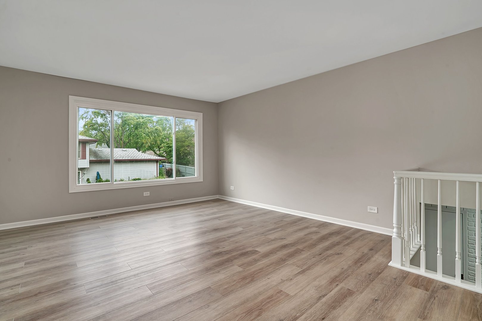 161 South Schmidt Road Bolingbrook, IL 60440 - Photo 4 of 26 a view of an empty room with wooden floor and a window