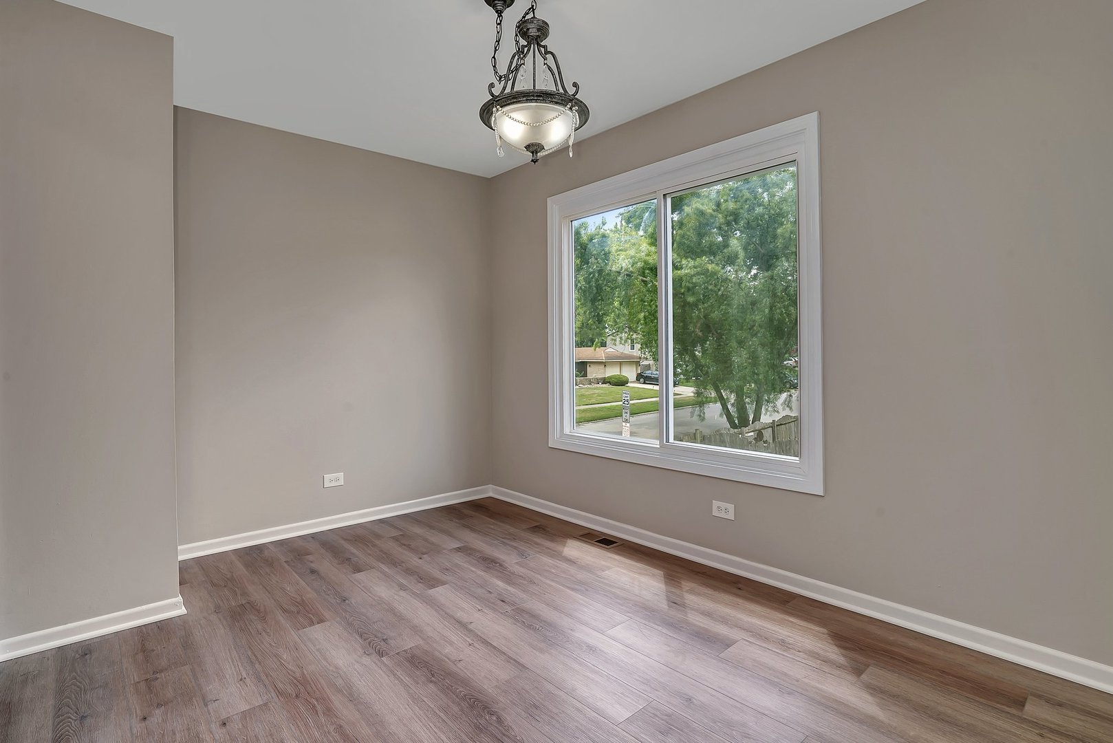 161 South Schmidt Road Bolingbrook, IL 60440 - Photo 5 of 26 a view of an empty room with wooden floor and a window