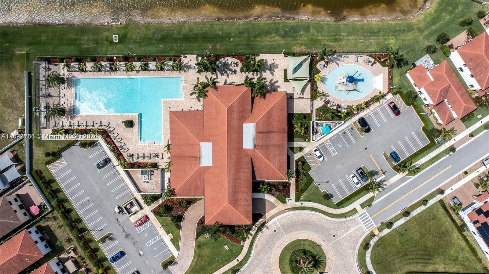 an aerial view of a house with a swimming pool patio and outdoor seating