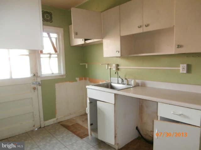 1026 Arncliffe Road Essex, MD 21221 - Photo 4 of 17 a room with a sink cabinets and utility