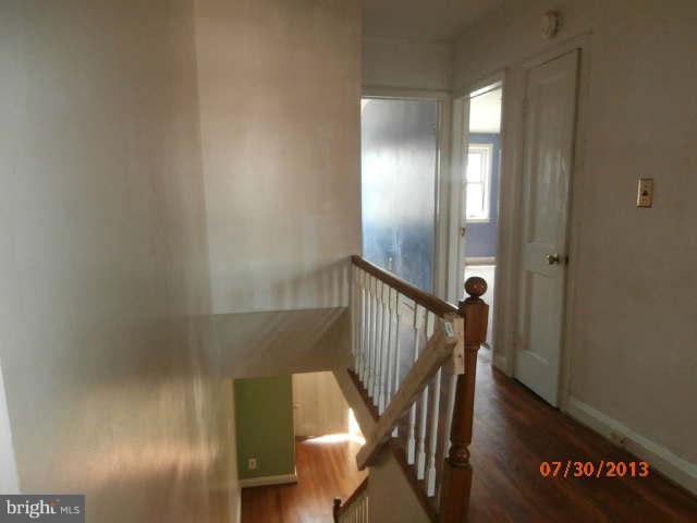 1026 Arncliffe Road Essex, MD 21221 - Photo 8 of 17 a view of a hallway with wooden floor and stairs